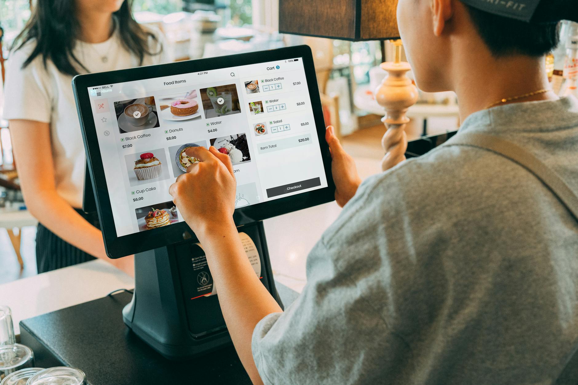 a close up shot of a cashier using a point of sale system